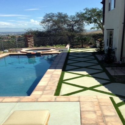 Artificial grass installed between pavers by swimming pool synthetic turf installation