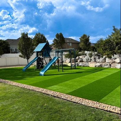 Playground with slides surrounded by artificial grass.