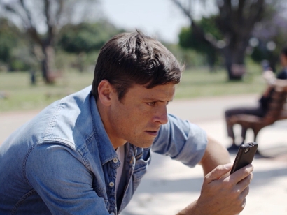 young man looking for a quote on cellphone