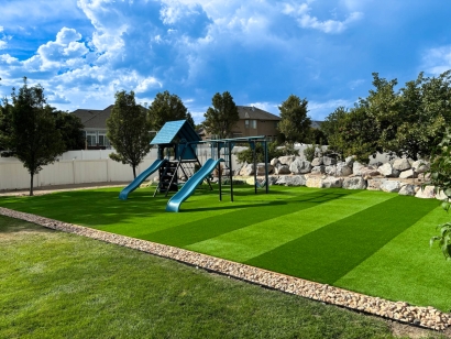 Playground with slides surrounded by artificial grass.